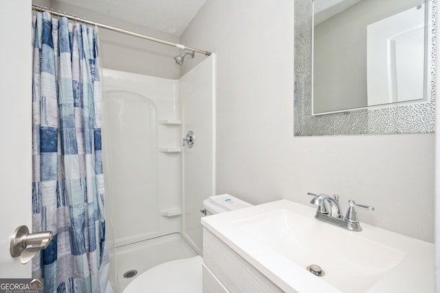 bathroom with vanity, toilet, and curtained shower