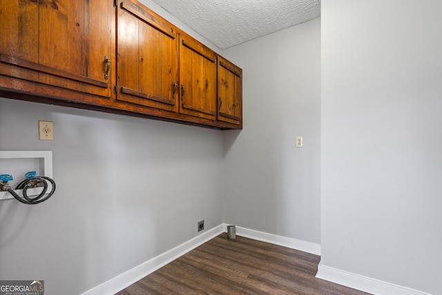 laundry room with baseboards, washer hookup, cabinet space, electric dryer hookup, and a textured ceiling