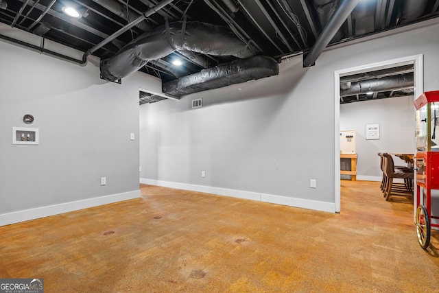 finished basement with visible vents and baseboards