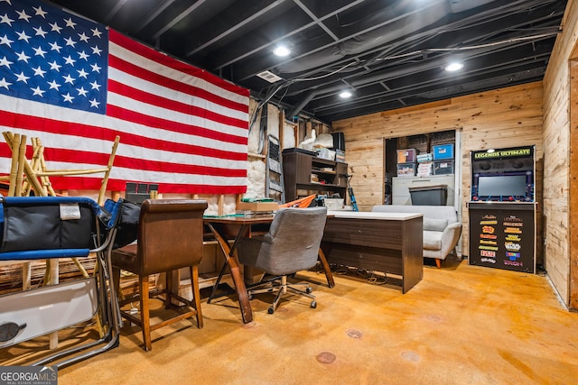 office with wooden walls and concrete flooring