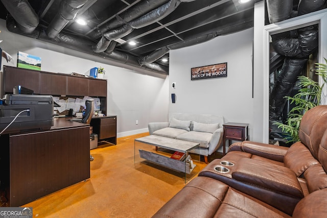 living area featuring baseboards and concrete flooring