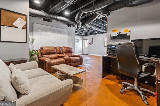 home office with concrete floors and baseboards