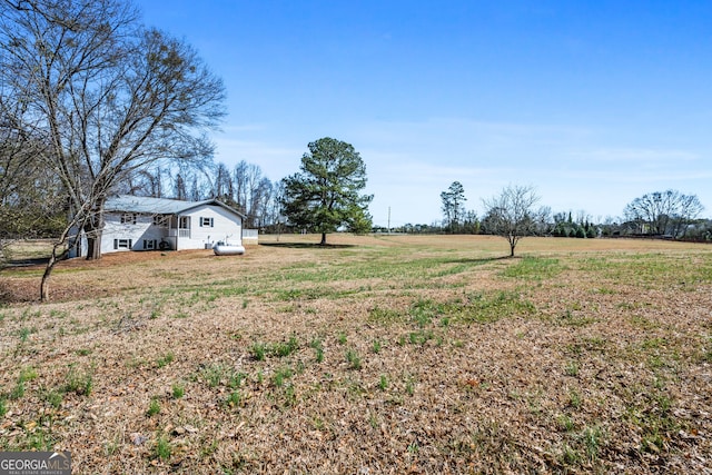 view of yard with a rural view