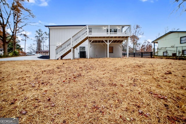 rear view of property with a deck and central air condition unit