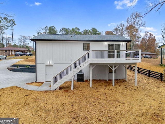 rear view of property with a deck and central air condition unit