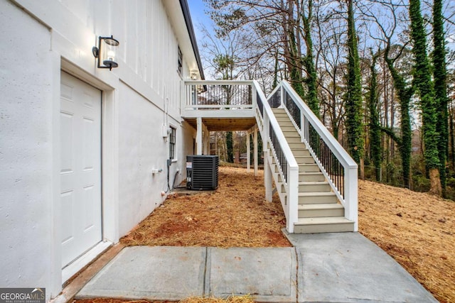 view of home's exterior with central AC unit and a wooden deck