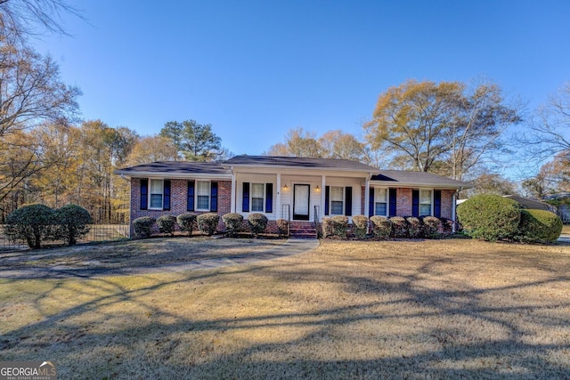 single story home with a porch and a front yard