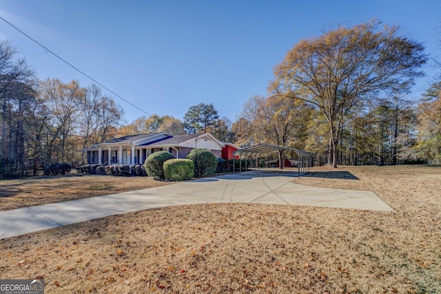 exterior space with covered porch and a carport