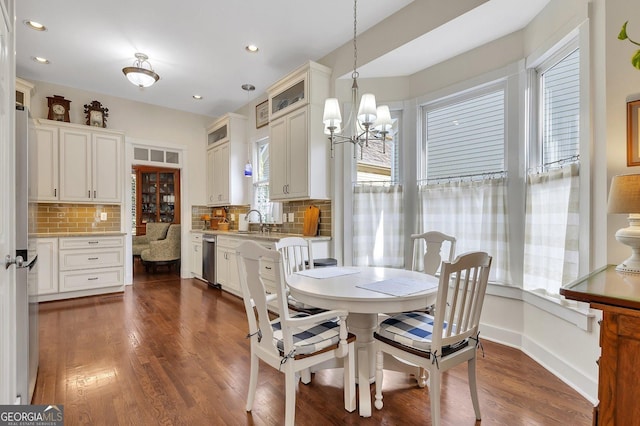 dining room with a chandelier, dark hardwood / wood-style floors, and sink