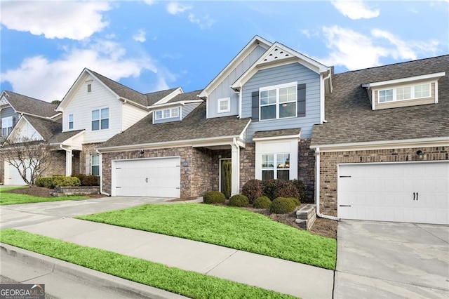 view of front of home with a front yard and a garage