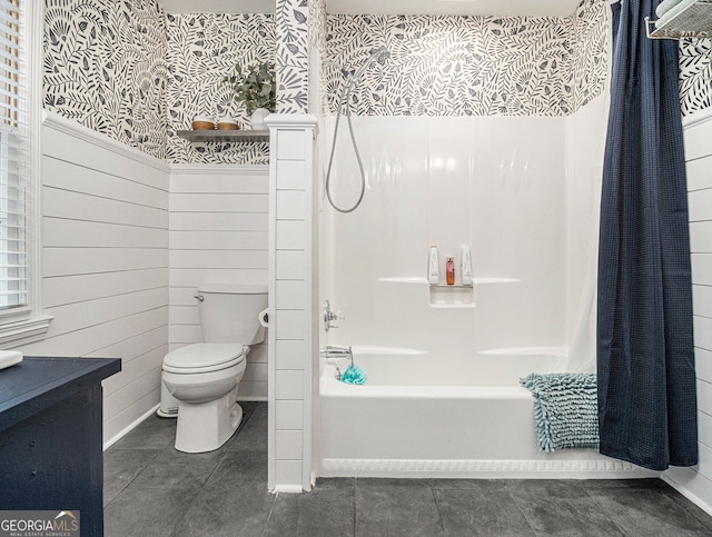 bathroom featuring wood walls, tile patterned flooring, shower / bath combo with shower curtain, and toilet