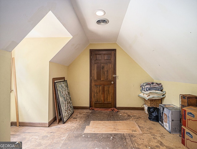 additional living space with lofted ceiling, visible vents, and baseboards