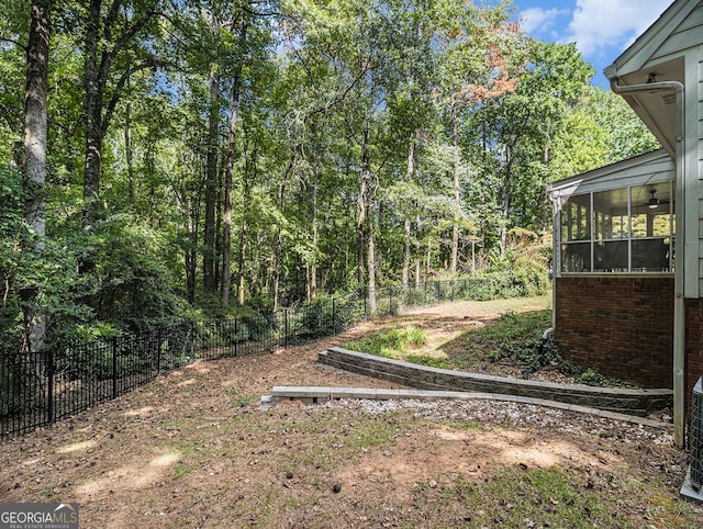 view of yard with a sunroom and fence