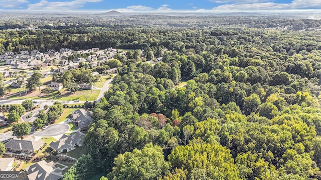 drone / aerial view with a residential view and a wooded view