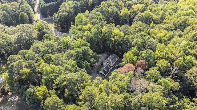 drone / aerial view featuring a wooded view