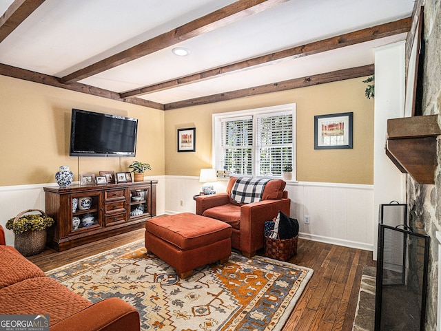 living room featuring a wainscoted wall, wood-type flooring, and beamed ceiling