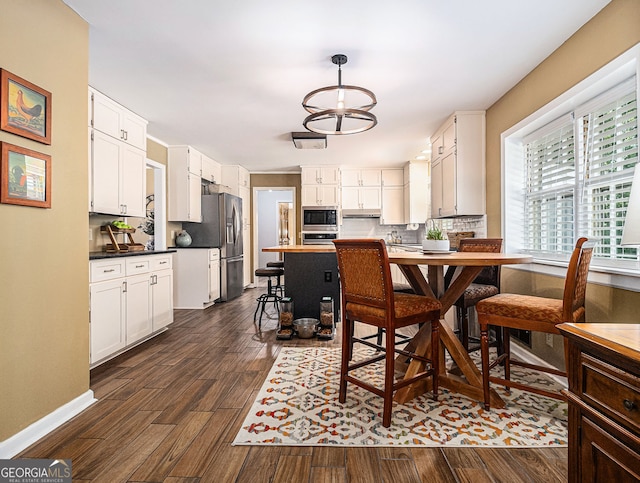 dining space with dark wood-type flooring and baseboards