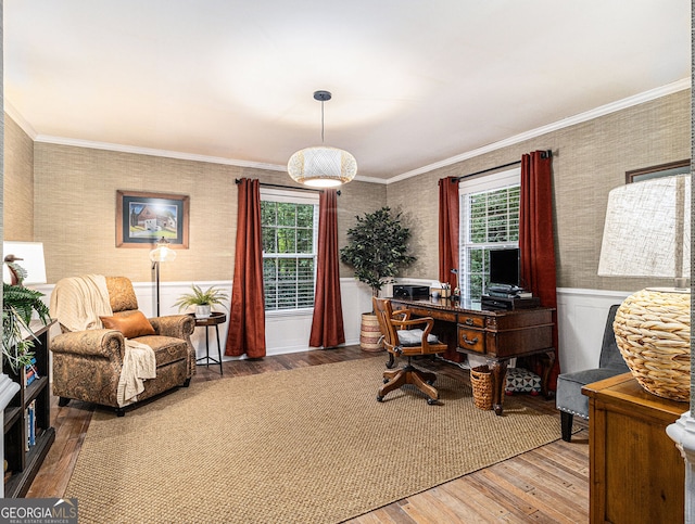 office with a wainscoted wall, crown molding, wood finished floors, and wallpapered walls