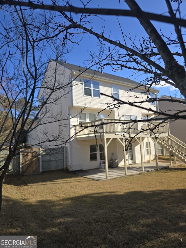 rear view of property featuring a yard and a patio