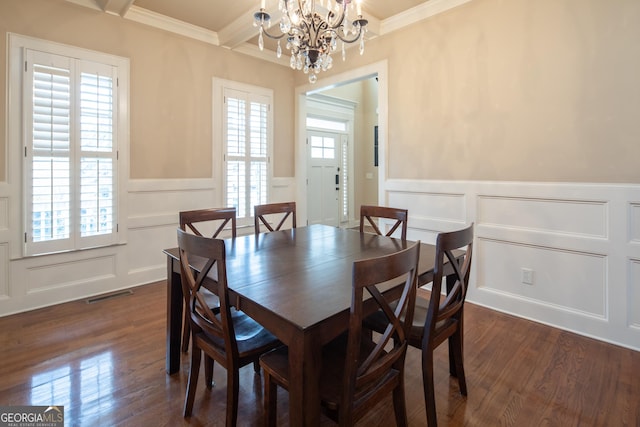 dining area with a notable chandelier, beamed ceiling, crown molding, and dark hardwood / wood-style flooring