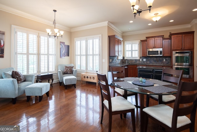 dining room with a notable chandelier, crown molding, and dark wood-type flooring