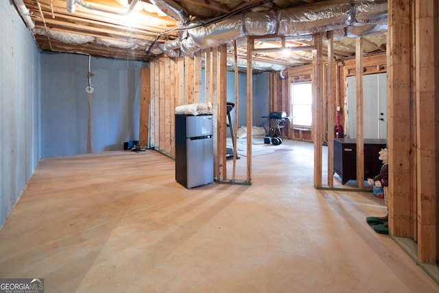 basement featuring stainless steel fridge