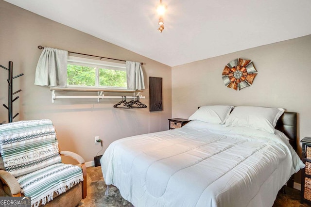 carpeted bedroom with lofted ceiling