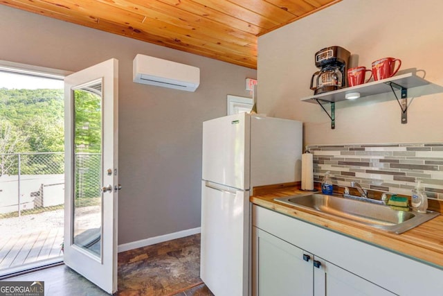 kitchen with a wall mounted air conditioner, wooden ceiling, sink, decorative backsplash, and butcher block counters