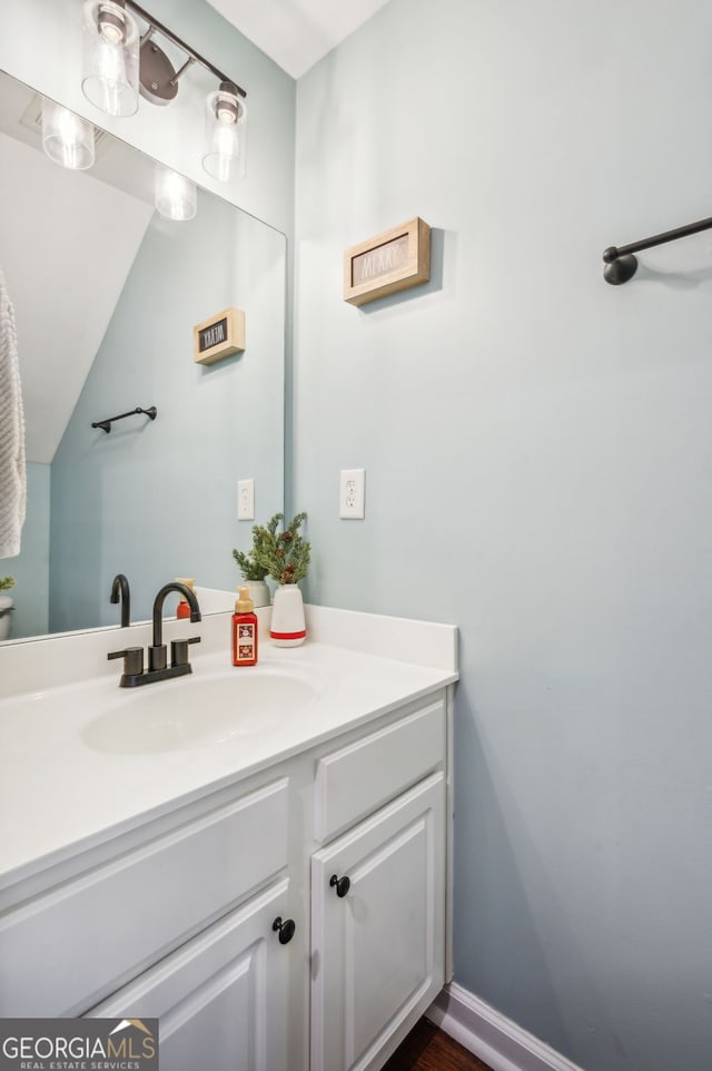 bathroom featuring vanity and baseboards