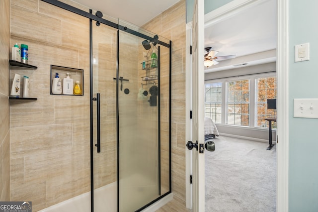 bathroom with ceiling fan, a stall shower, and visible vents