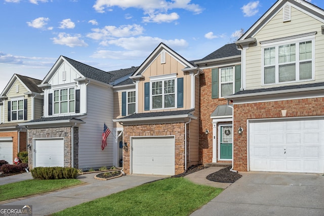 view of front of property with brick siding, concrete driveway, board and batten siding, a garage, and stone siding