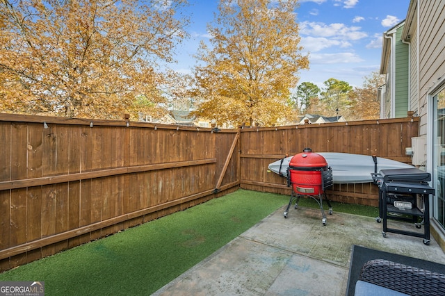 view of patio featuring a fenced backyard, a jacuzzi, and grilling area