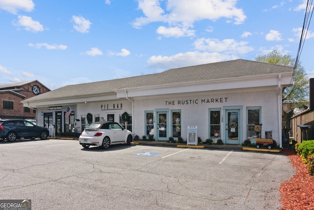 view of building exterior featuring uncovered parking