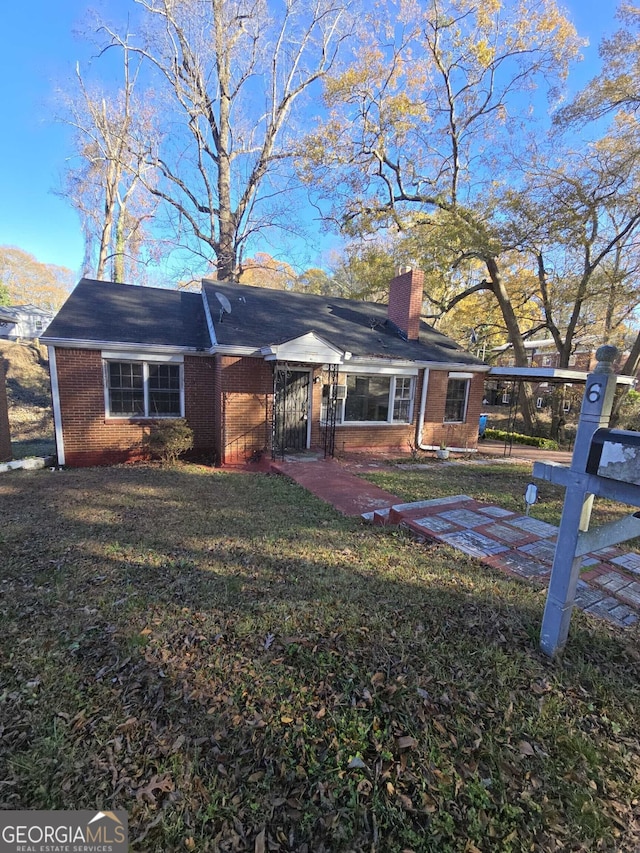 back of house with a lawn