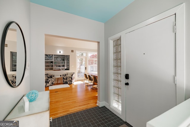 foyer entrance featuring dark hardwood / wood-style floors