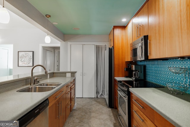 kitchen featuring appliances with stainless steel finishes, backsplash, pendant lighting, and sink