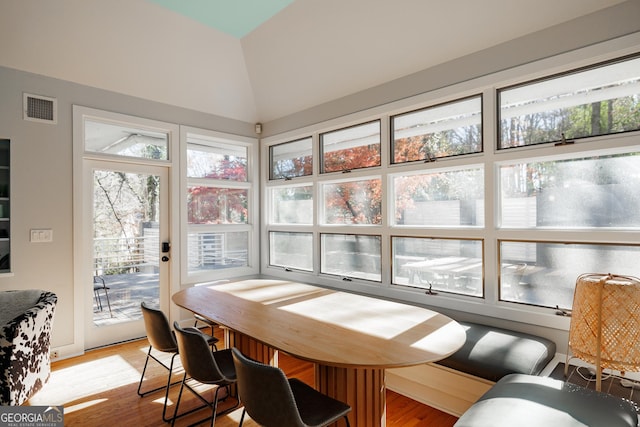 interior space featuring hardwood / wood-style floors and lofted ceiling