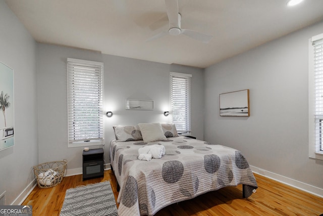 bedroom featuring light hardwood / wood-style flooring and ceiling fan