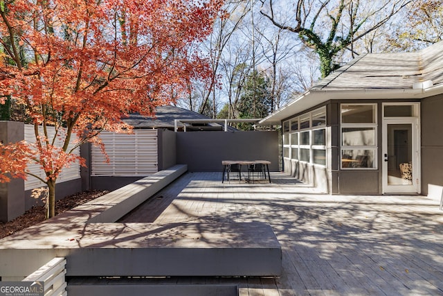 view of patio / terrace with a wooden deck and a sunroom