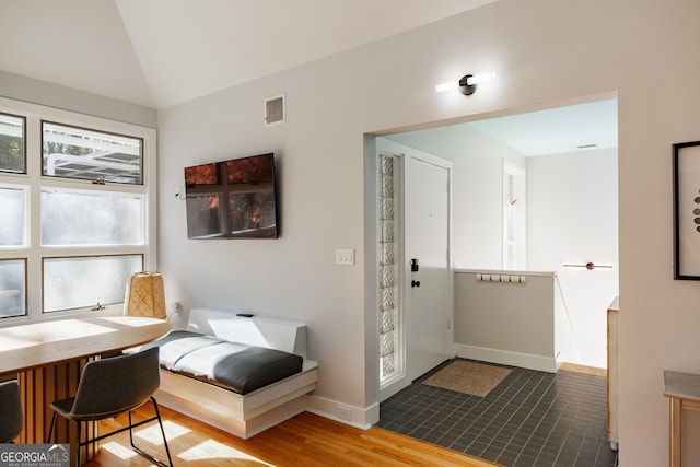 interior space with lofted ceiling and hardwood / wood-style flooring