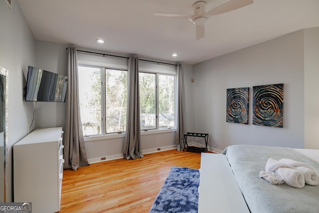 bedroom with ceiling fan and light hardwood / wood-style flooring