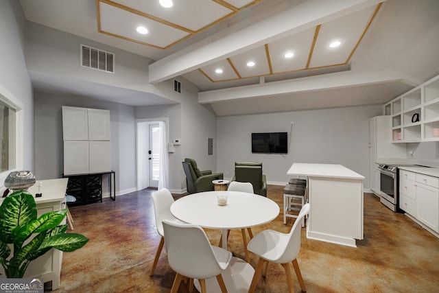 dining space featuring beamed ceiling