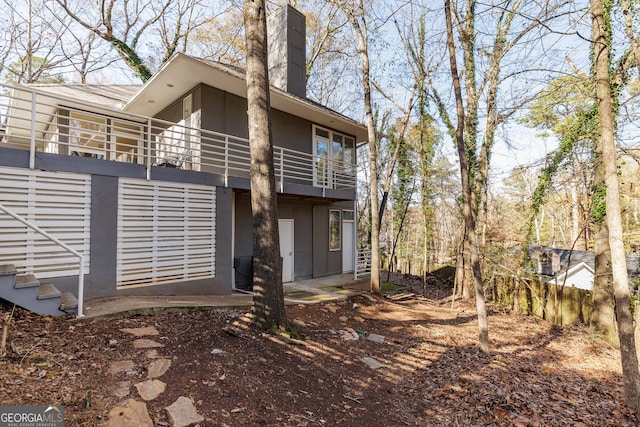 rear view of house featuring a balcony