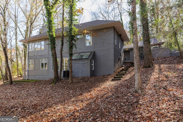 back of house featuring central air condition unit