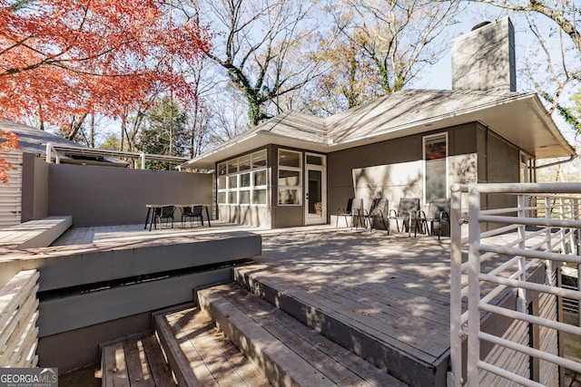 wooden deck with a sunroom