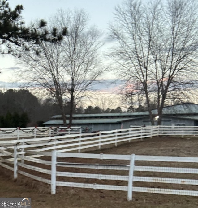 yard at dusk with a rural view