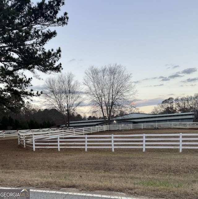 yard at dusk with a rural view