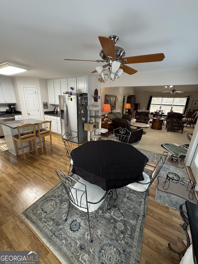 living room with light wood-type flooring and ceiling fan