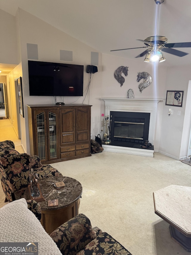 carpeted living room with ceiling fan and lofted ceiling