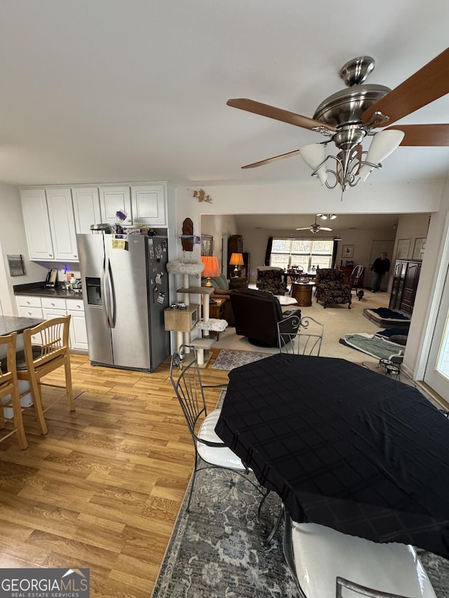 dining area with light hardwood / wood-style flooring and ceiling fan